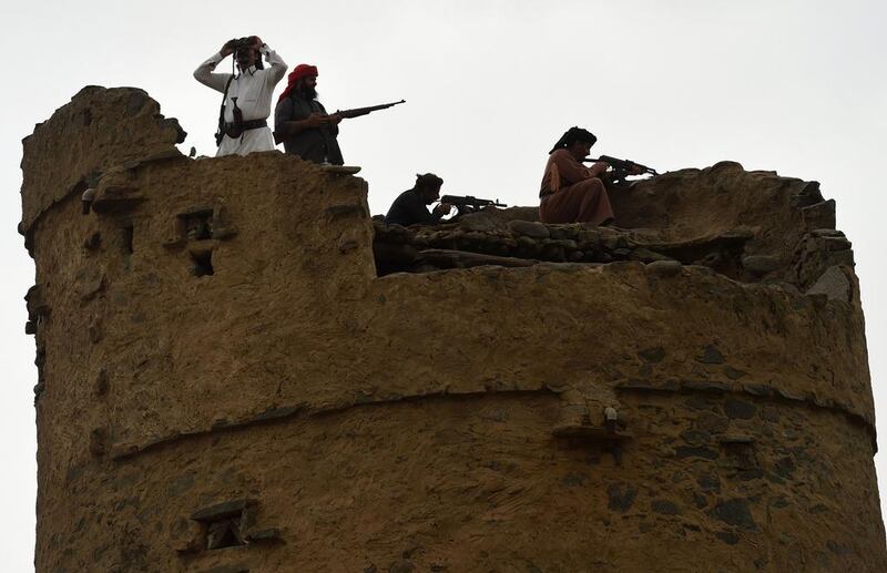 Armed Saudi volunteers, from the Fayfa tribes, stand atop an ancient tower during a tribal gathering in the Jizan province, near the Saudi-Yemeni border, on April 14, 2015. The tribes have decided to support Saudi Arabia's King Salman bin Abdulaziz and defend their mountainous area from any attack from the Yemeni side. Fayez Nureldine/AFP Photo


