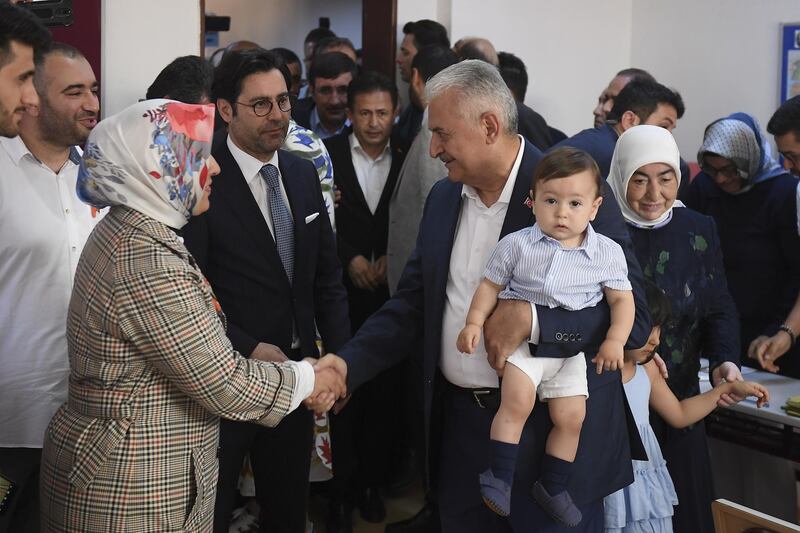 Mr Yildirim with his grandson. Akin Celiktas / EPA