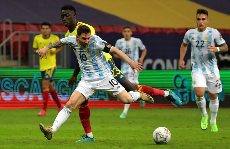 Lionel Messi and Colombia's Davinson Sanchez vie for the ball.