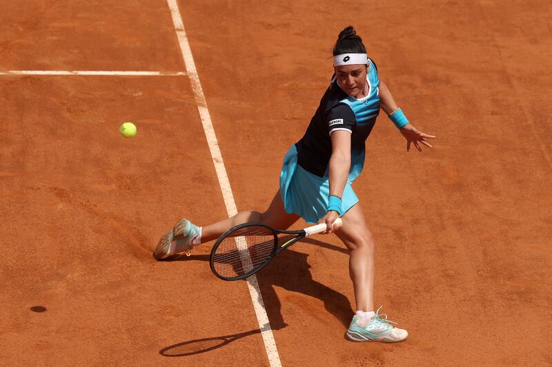 Ons Jabeur plays a backhand against Iga Swiatek. Getty