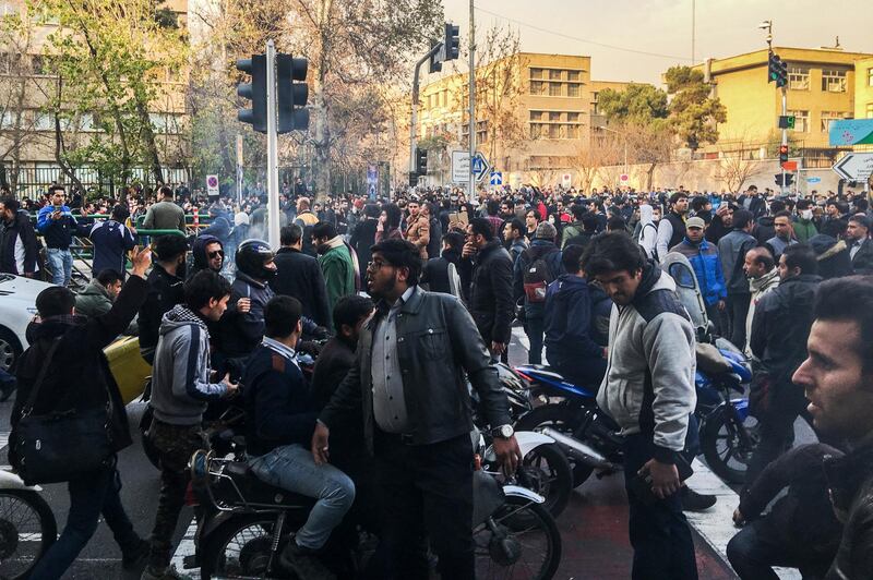 This photo shows people gathering to protest against Iran's weak economy in Tehran, Iran, on December 30. AP