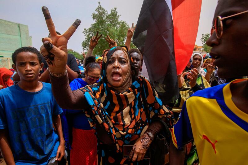 A Sudanese protester flashes the V-sign during a mass demonstration against Sudan's ruling generals in Khartoum on June 30, 2019.  AFP