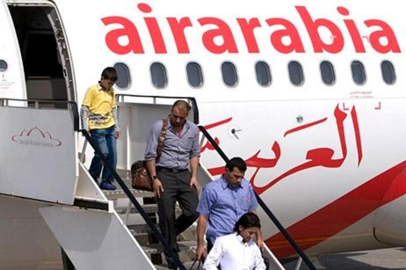 Sharjah - October 4, 2009 - Passengers arrive aboard an Air Arabia jet at Sharjah International Airport in Sharjah, October, 4, 2009. (Photo by Jeff Topping/ The National) *** Local Caption ***  JT013-1004-AIR ARABIA_F8Q7111.jpg
