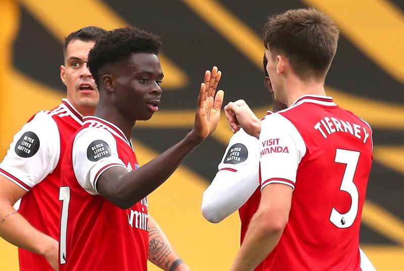 epa08527212 Bukayo Saka (C) of Arsenal celebrates with teammates after scoring the 1-0 lead during the English Premier League match between Wolverhampton Wanderers and Arsenal London in Wolverhampton, Britain, 04 July 2020.  EPA/Cath Ivill/NMC/Pool EDITORIAL USE ONLY. No use with unauthorized audio, video, data, fixture lists, club/league logos or 'live' services. Online in-match use limited to 120 images, no video emulation. No use in betting, games or single club/league/player publications.