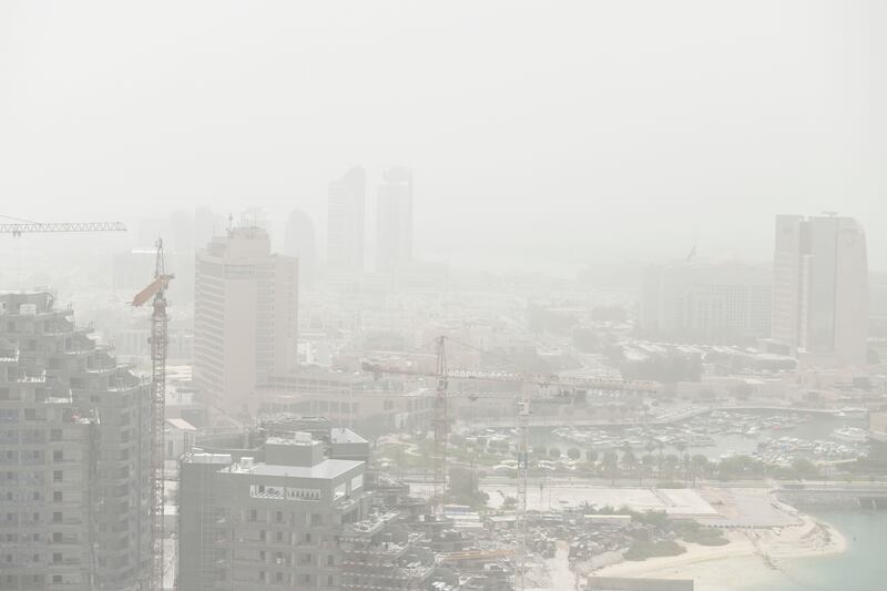 Abu Dhabi city is difficult to see through the dust. Khushnum Bhandari / The National