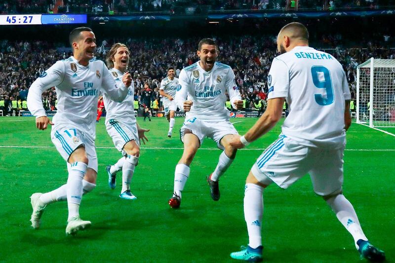 Real Madrid's French forward Karim Benzema (R) celebrates with Real Madrid's Spanish midfielder Lucas Vazquez (L), Real Madrid's Croatian midfielder Luka Modric (C) and Real Madrid's Croatian midfielder Mateo Kovacic after scoring a second goal during the UEFA Champions League semi-final second leg football match between Real Madrid and Bayern Munich at the Santiago Bernabeu Stadium in Madrid on May 1, 2018. / AFP PHOTO / OSCAR DEL POZO