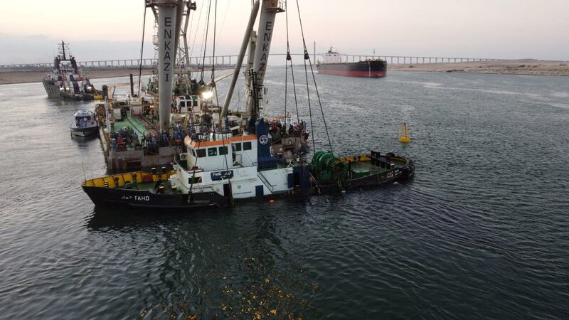 The Suez Canal Authority used a crane to recover the tugboat 'Fahd', which sank after colliding with a tanker. Reuters