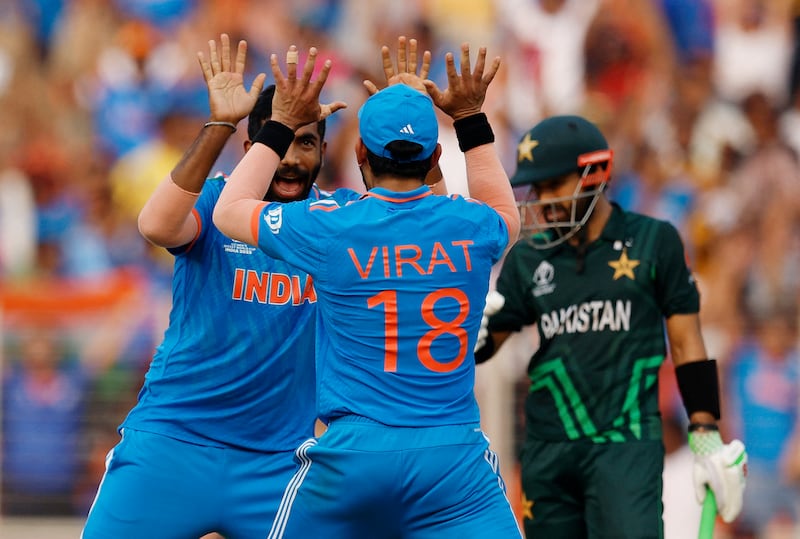 India's Jasprit Bumrah celebrates with Virat Kohli after taking the wicket of Pakistan's Mohammad Rizwan. Reuters