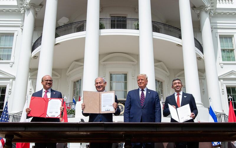 (L-R)Bahrain Foreign Minister Abdullatif al-Zayani, Israeli Prime Minister Benjamin Netanyahu, US President Donald Trump, and UAE Foreign Minister Abdullah bin Zayed Al-Nahyan hold up documents after participating in the signing of the Abraham Accords where the countries of Bahrain and the United Arab Emirates recognize Israel, at the White House in Washington, DC, September 15, 2020. - Israeli Prime Minister Benjamin Netanyahu and the foreign ministers of Bahrain and the United Arab Emirates arrived September 15, 2020 at the White House to sign historic accords normalizing ties between the Jewish and Arab states. (Photo by SAUL LOEB / AFP)