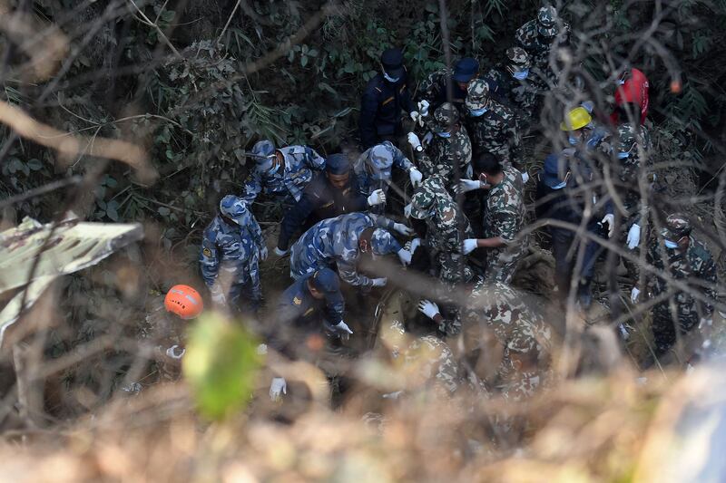 Rescuers inspect the wreckage at the site of the Yeti Airlines plane crash in Pokhara, Nepal. AFP