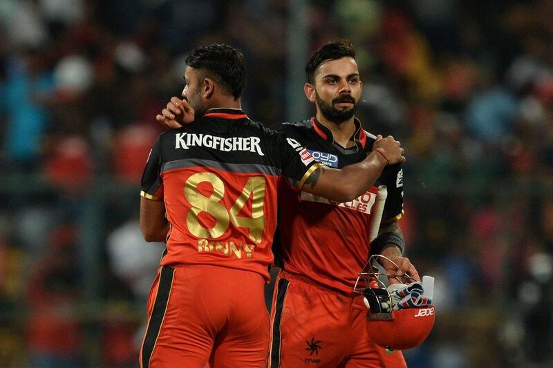 Royal Challengers Bangalore captain and batsman Virat Kohli (R) celebrates winning the 2016 Indian Premier League (IPL) Twenty20 cricket match between Royal Challengers Bangalore and Rising Pune Supergiants, at The M Chinnaswamy Stadium in Bangalore on May 7, 2016. Royal Challengers Bangalore are chasing a target of 192 runs set by Rising Pune Supergiants.  Manjunath Kiran / AFP