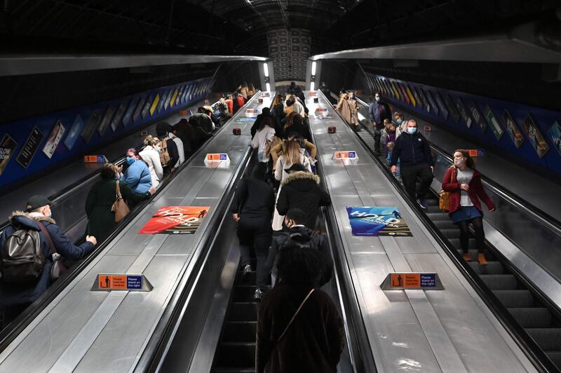 Travellers  ride an escalator in a train station in London as England prepares to enter into a second lockdown in an effort to stem soaring infections. AFP