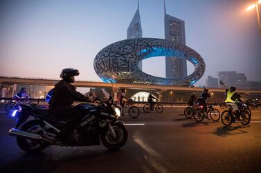 Dubai, United Arab Emirates: Participants with The Museum of the Future at the background and Emirates Towers at the Dubai Fitness Challenge Ride at Sheikh Zayed Road.  Ruel Pableo for The National