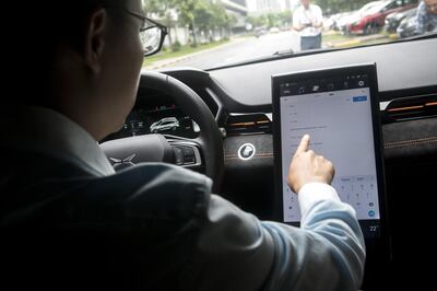 Henry Xia, co-founder and president of Xpeng Motors Technology Ltd., demonstrates the navigation function on the control panel of a 1.0 vehicle in Guangzhou, China, on Wednesday, June 6, 2018. Though Xpeng hasn't delivered a single vehicle, doesn't own a factory and hasn't obtained a production license from the government, the Chinese electric automaker expects to raise more than $600 million this month from investors that include Alibaba, valuing it close to $4 billion, according to a person familiar with the fundraising. Photographer: Giulia Marchi/Bloomberg