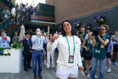 Ons Jabeur greets her supporters with the runners up trophy following defeat to Elena Rybakina in The Final of the Ladies' Singles on day thirteen of the 2022 Wimbledon Championships at the All England Lawn Tennis and Croquet Club, Wimbledon. Picture date: Saturday July 9, 2022.