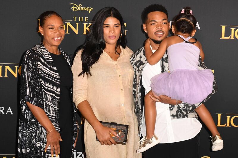 Chance The Rapper, wife Kirsten Corley and daughter Kensli Bennett arrive for the world premiere of Disney's 'The Lion King' at the Dolby Theatre on July 9, 2019. AFP