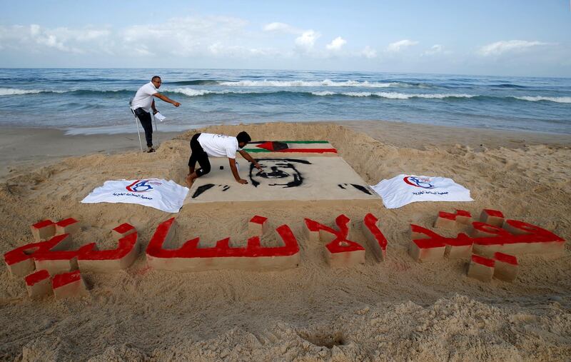 Palestinian artists put the final touches on a sand sculpture paying tribute to Kuwait's late Emir Sheikh Sabah al-Ahmed al-Sabah, on a beach in Gaza City. Reuters