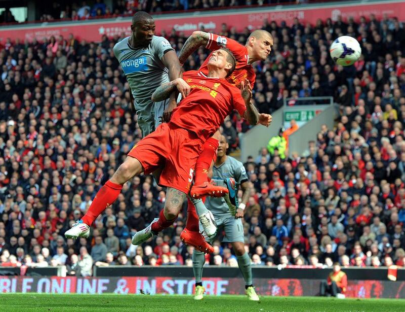 Newcastle United’s Shola Ameobi, left, in action with Liverpool’s Daniel Agger, centre, and Martin Skrtel during their English Premier League match at the Anfield Road, in Liverpool, Britain on May 11, 2014. EPA/PETER POWELL