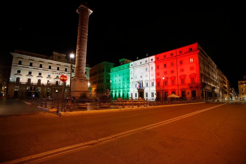 Palazzo Chigi Government office is lit with the color of the Italian flag. Since an 11 p.m.-5 a.m. curfew took effect Friday, people can only move around during those hours for reasons of work, health or necessity. AP Photo