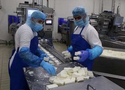 Workers sort halloumi cheese at the Petrou Bros Dairy in Aradippou, Cyprus, April 2, 2021. Picture taken April 2, 2021. REUTERS/Yiannis Kourtoglou