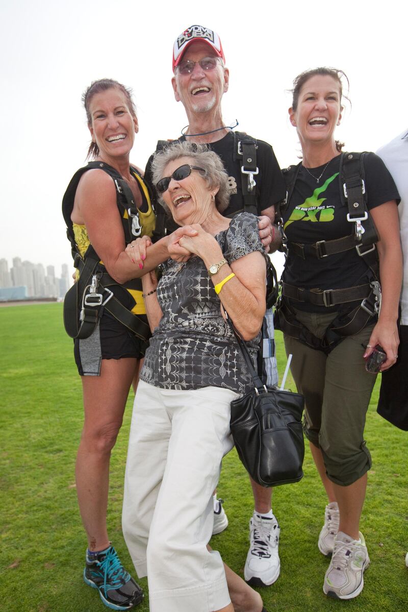 Dubai, United Arab Emirates, Apr 10, 2013 -  Dick Corbit, center with his daughters Lynn (left), Lisa (right) and his wife Ella, below, after his parachute jump at skydive. Corbit is the oldest jumper to skydive at skydive Dubai and today is his 86 birthay. ( Jaime Puebla / The National Newspaper ) 