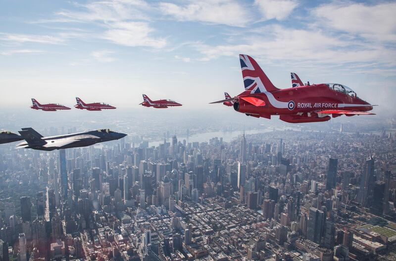 Britain's Royal Air Force aerobatic team the Red Arrows fly with a US Air Force F-35 aircraft over New York City.  Reuters