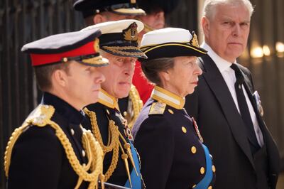 King Charles III, Princess Anne and Prince Andrew watch on as Queen Elizabeth's funeral cortege leaves Westminster Abbey. Getty