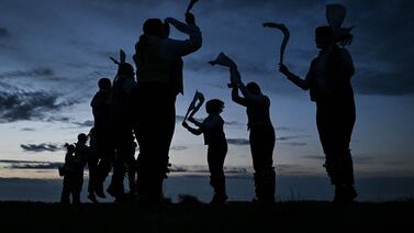 Miserden Morris dancers perform at sunrise on Rodborough Common, in Stroud, western England, as part of the May Day celebrations. AFP