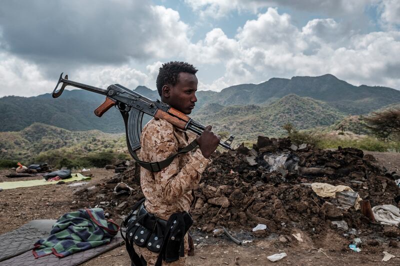 A member of the Afar Special Forces stands in front of the debris of a house on the outskirts of the village of Bisober in Tigray.
