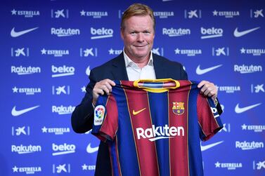Ronald Koeman poses with a Barcelona shirt during his presentation as the club's manager. AFP
