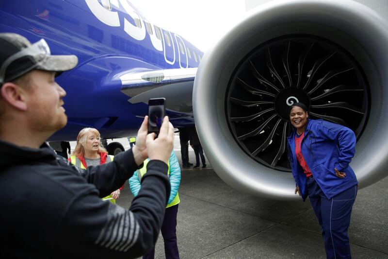 Boeing employee Tronja Nagra, quality insurance inspector for the 737 engine, poses in front of a 737 MAX 8 produced for Southwest Airlines as Boeing celebrates the 10,000th 737 to come off the production line in Renton, Washington, U.S. March 13, 2018.  REUTERS/Jason Redmond