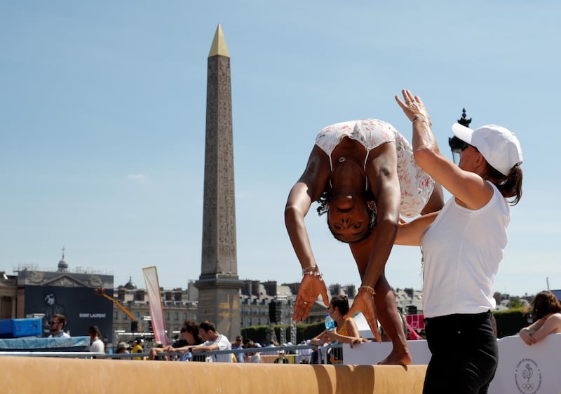 A member of the public takes part in sporting events at Place de la Concorde, which has been turned into a giant Olympic park ahead of the Paris 2024 Olympics, in Paris, France.  Reuters