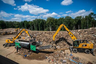 The clean-up from the German floods continues with waste being moved into a grinding container in Niederzissen, western Germany. AFP 