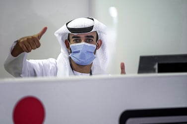 Abu Dhabi, United Arab Emirates, May 6, 2020. the new Ambulatory Healthcare Services, a SEHA Health System Facility, National Screening Project in Mussafah Industrial Area in Abu Dhabi. -- A testing center staffer gives the thumbs up sign. Victor Besa / The National Section: NA Reporter: Nick Webster