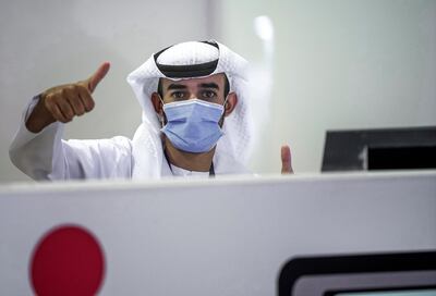 Abu Dhabi, United Arab Emirates, May 6, 2020. the new Ambulatory Healthcare Services, a SEHA Health System Facility, National Screening Project in Mussafah Industrial Area in Abu Dhabi.  --  A testing center staffer gives the thumbs up sign.
Victor Besa / The National
Section:  NA
Reporter:  Nick Webster