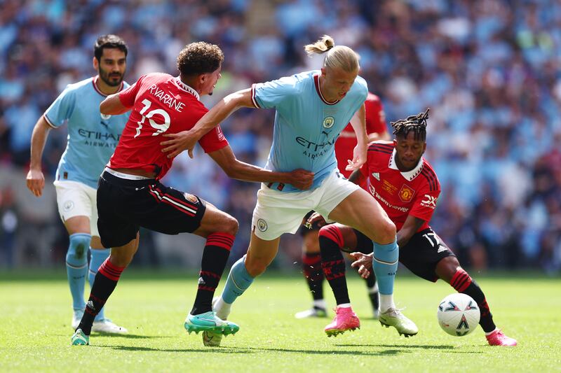 Erling Haaland of Manchester City is challenged by Raphael Varane and Fred of Manchester United. Getty