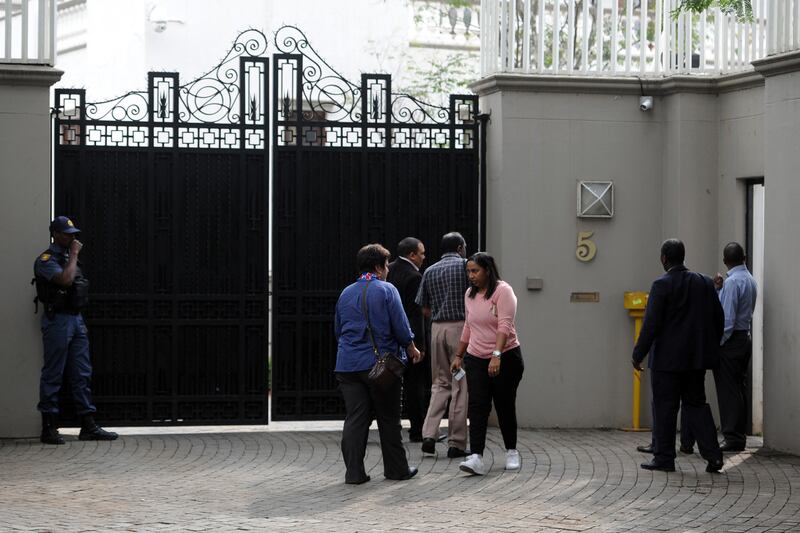 South African law enforcement agencies arrive to search the Gupta family compound in April 2018 in Johannesburg. AFP