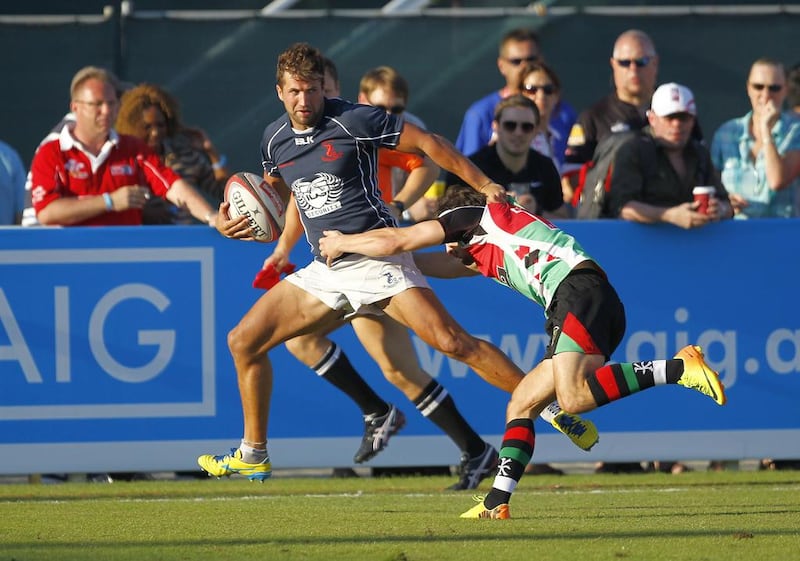 ebel Ali Dragons, in blue, were able to run past Abu Dhabi Harlequins, in green and red, right to the Dubai Rugby Sevens Gulf Men's League title at The Sevens, Dubai, on Saturday. Jake Badger for The National