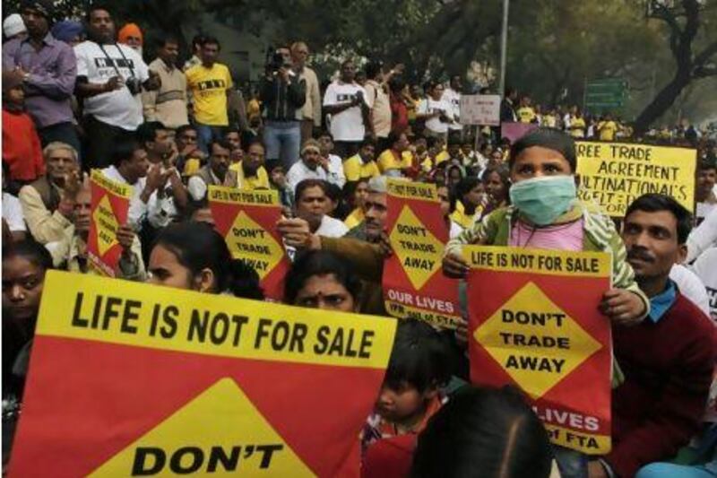 People living with HIV and cancer hold placards during a protest in New Delhi. Thousands of people living with HIV and cancer held a rally against trade negotiations between India and the EU that would restrict access to lifesaving drugs and medicines.