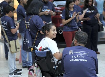 Dubai, April 07, 2018:  Shobhika Kalra on a wheelchair with the volunteers heading out to spread awareness about the accesible for wheelchair users outside th emeracto mall in Dubai. Satish Kumar for the National /Story by Ramola Talwar