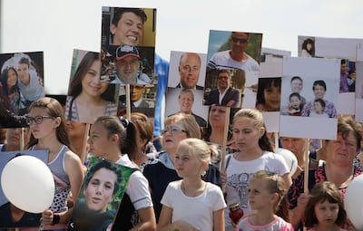 People gather near a monument for the victims of the Malaysia Airlines flight MH17 plane crash to mark the fourth anniversary of the accident near the village of Hrabove (Grabovo) in Donetsk Region, Ukraine July 17, 2018. REUTERS/Alexander Ermochenko NO RESALES. NO ARCHIVES.
