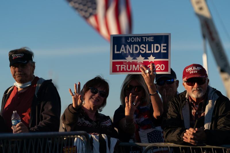 Attendees hold signs during a rally with U.S. President Donald Trump in Valdosta, Georgia, U.S. Bloomberg