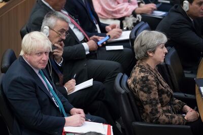 British Prime Minister Theresa May, right, and Foreign Secretary Boris Johnson attend a high level meeting, Wednesday, Sept. 20, 2017 at United Nations headquarters. (AP Photo/Mary Altaffer)