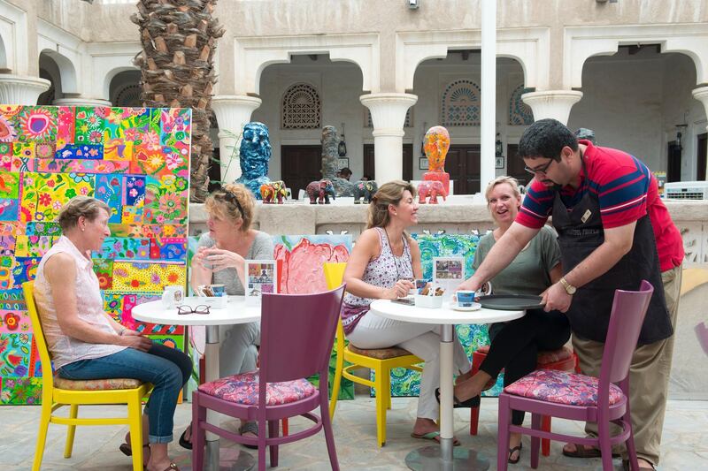 Student Zaid Jaffar serves people in a café at Mawaheb, a Dubai non-profit art studio for people with special needs. The studio encouraged the artists with disabilities to interact and communicate with people. Courtesy: Mawaheb