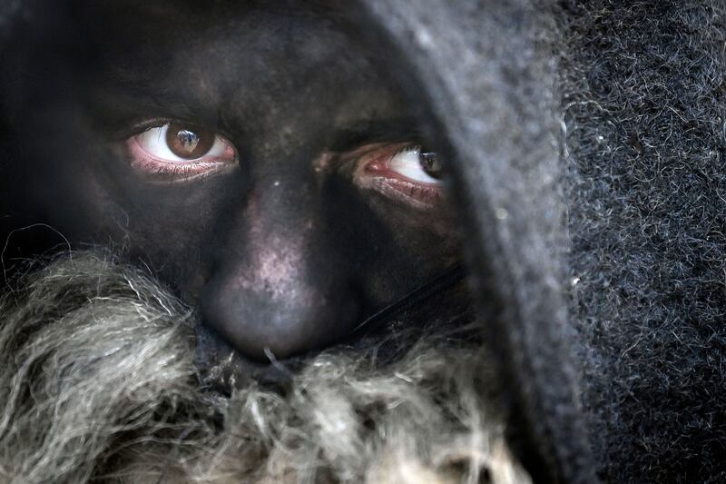 A dancer with a painted face performs a kukeri dance during the International Festival of the Masquerade Games in Pernik, Bulgaria.  AFP