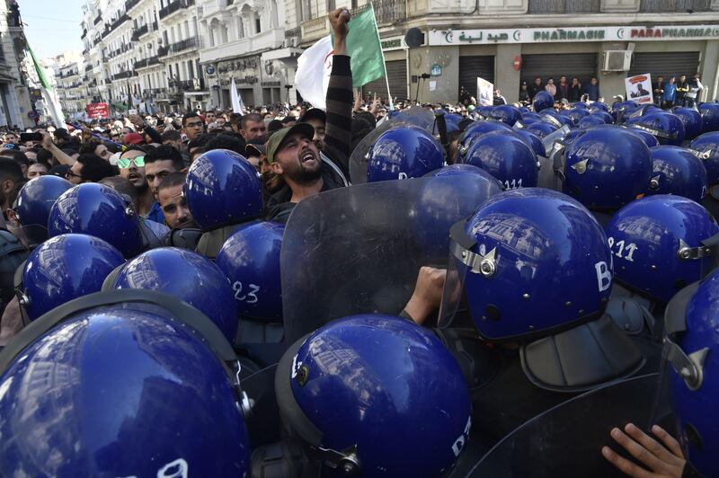 Algerian riot police block the progress of an anti-government demonstration heading towards the presidential palace in the capital Algiers.  AFP