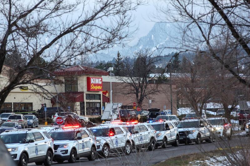 Law enforcement vehicles line up at the perimeter of a shooting site at a King Soopers grocery store. Reuters