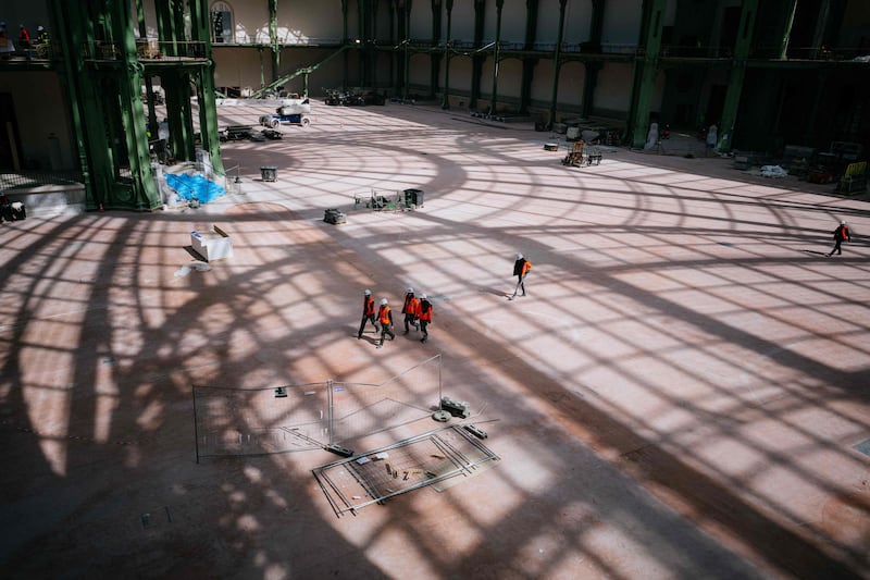 Construction workers at the site of Le Grand Palais in Paris, which will host the fencing and taekwondo events during the summer Olympics. AFP