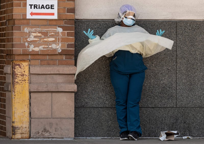 A medical worker takes a break outside a Brooklyn hospital in New York City. AFP
