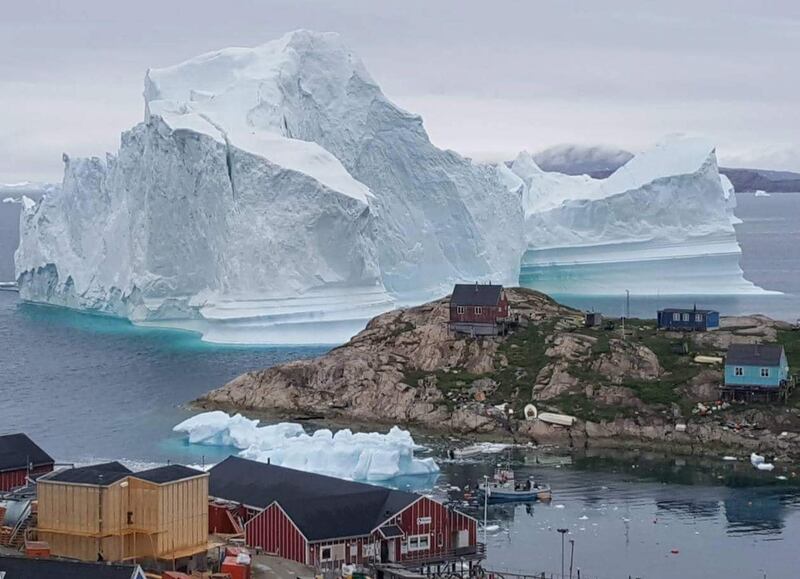 An iceberg passes the village of Innaarsuit, Greenland,  on July 12, 2018. Karl Petersen / EPA